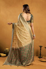 Woman wearing a traditional saree with a floral pattern against a beige background