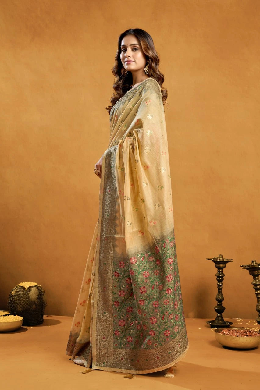 Woman in a traditional saree standing against an orange background