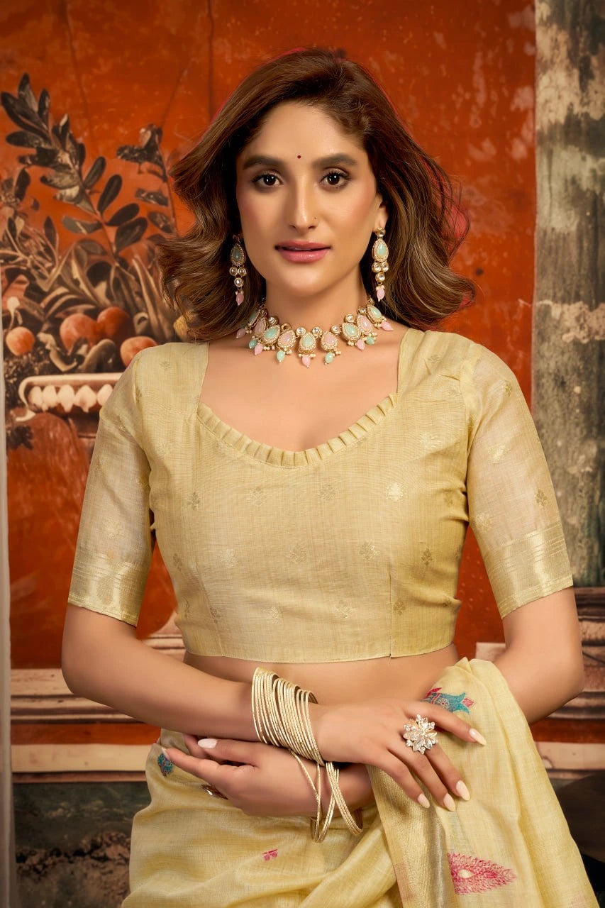 Woman in a traditional outfit with jewelry against an ornate wall.