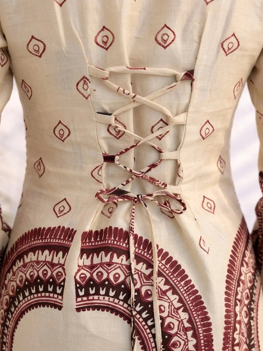 Close-up of a garment with red geometric patterns on a white background
