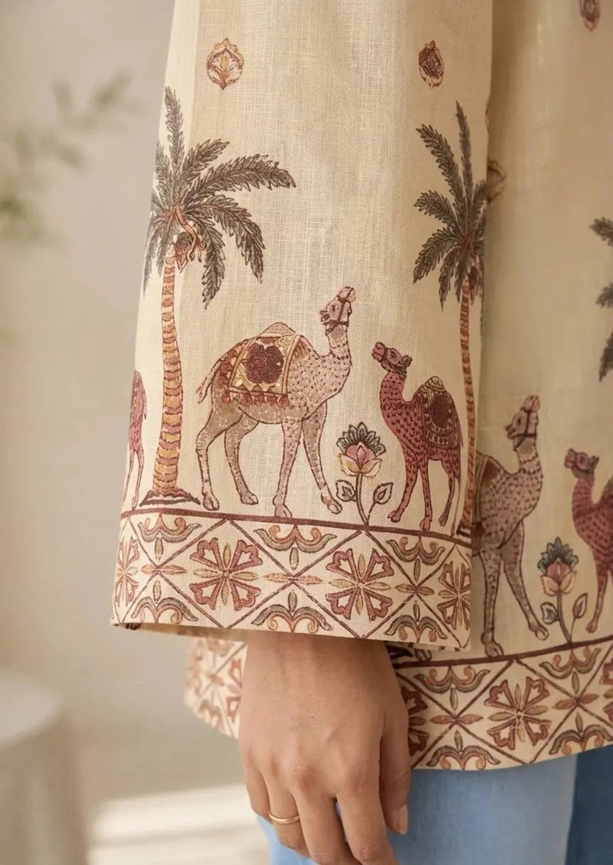 Close-up of a garment with camel and palm tree pattern