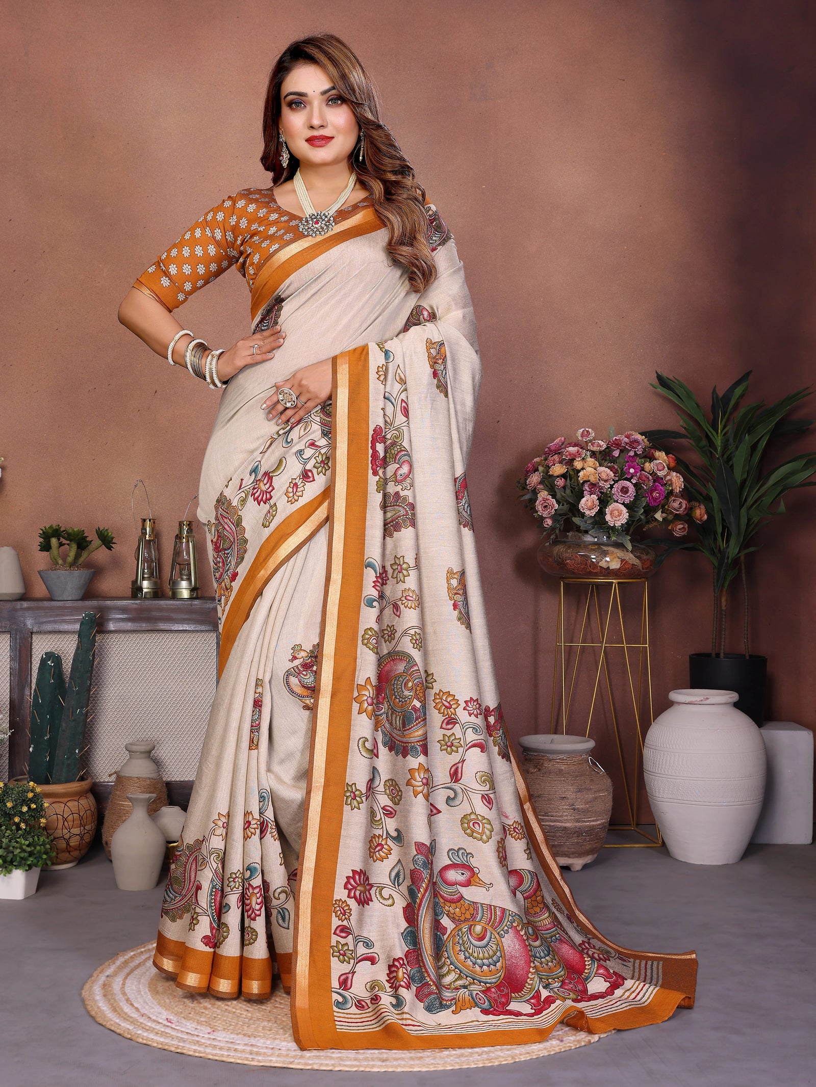 Woman in a traditional saree with a floral pattern in a decorated room.