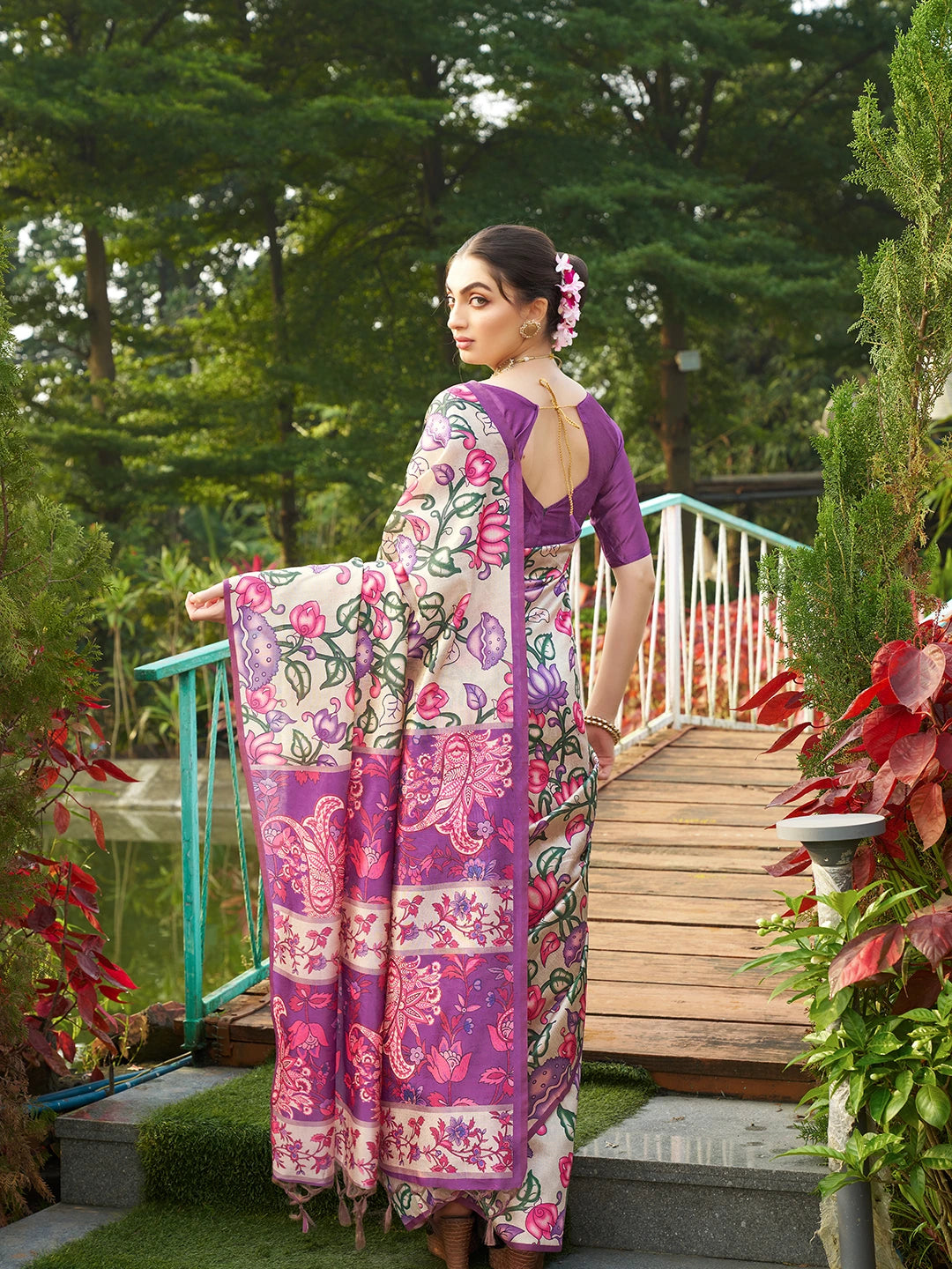 Elegant purple floral print saree with decorative woven pallu and matching blouse for festive occasions.