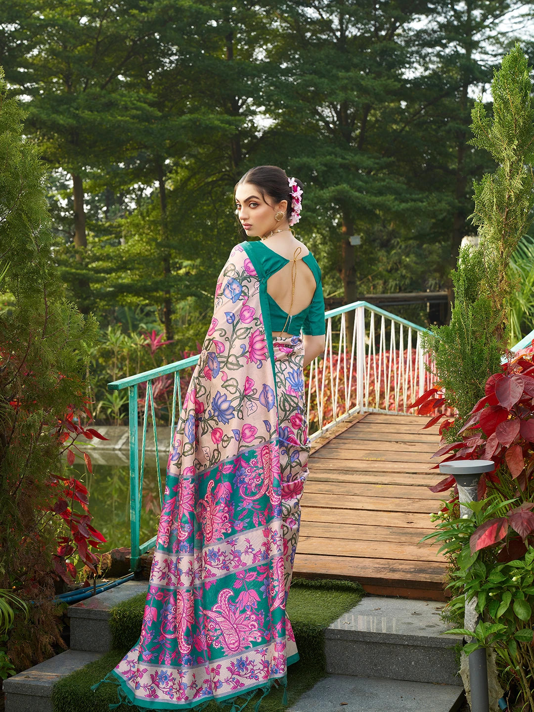 Beautiful teal green floral print saree featuring an artistic woven pallu and traditional ethnic design.