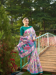 Women's teal green floral saree with decorative woven border and tassel pallu for festive occasions.