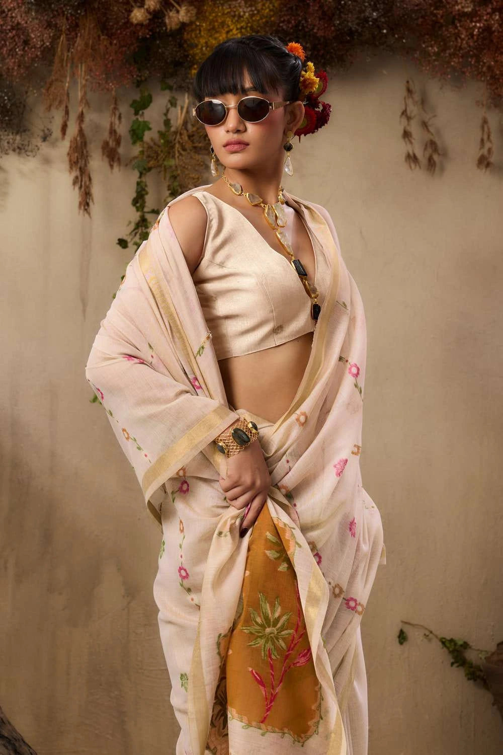 Her sleek updo with bangs and subtle makeup creates a refined contemporary look.
