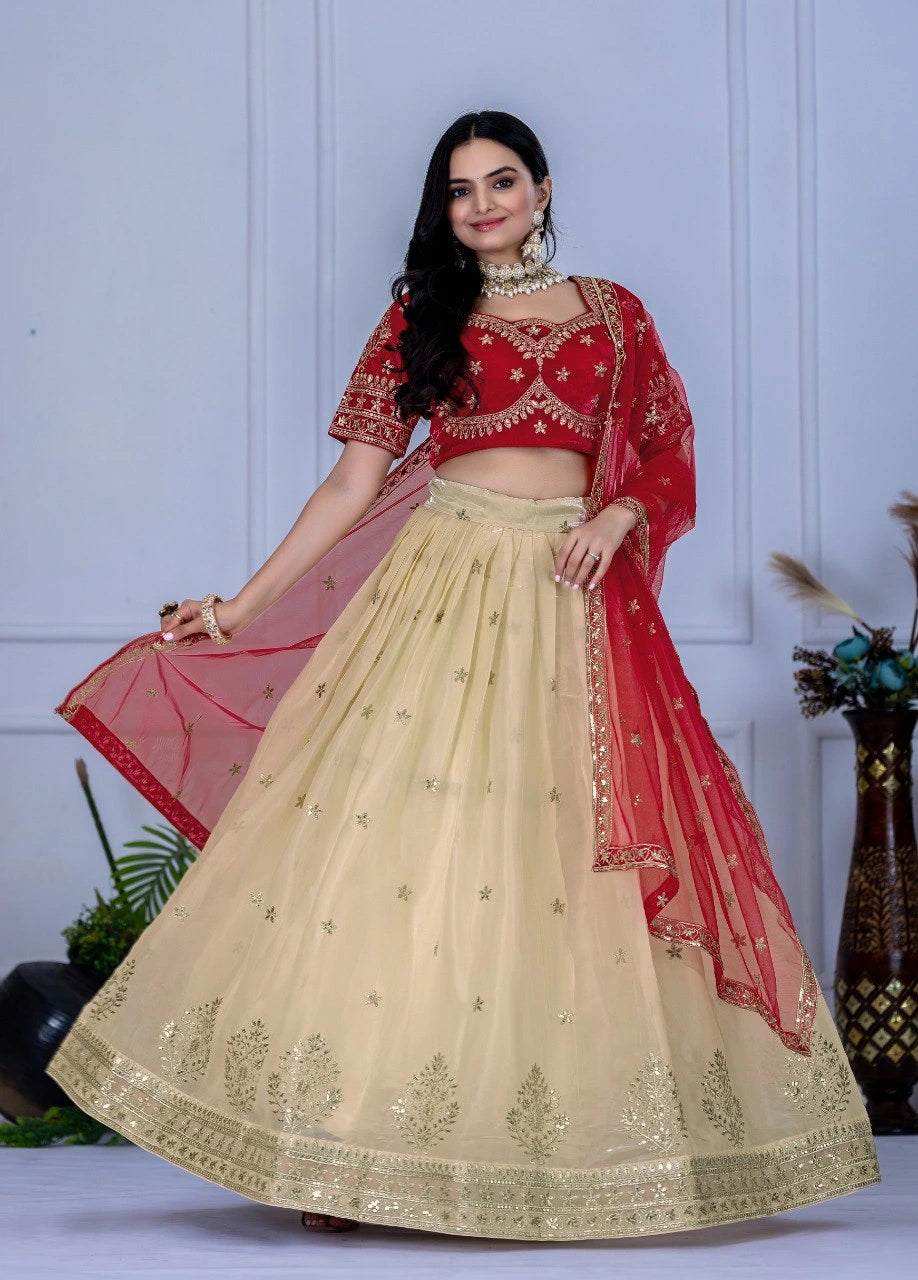 Woman wearing a red and beige embroidered traditional outfit against a light blue wall.