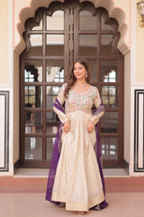 Woman in a traditional outfit standing in front of an ornate door.