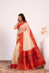 Woman wearing a red and beige saree with a white background