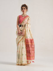 Elegant beige Patola silk saree featuring intricate geometric and floral weaving patterns. Includes a matching blouse piece. Ideal for festive and ceremonial occasions.