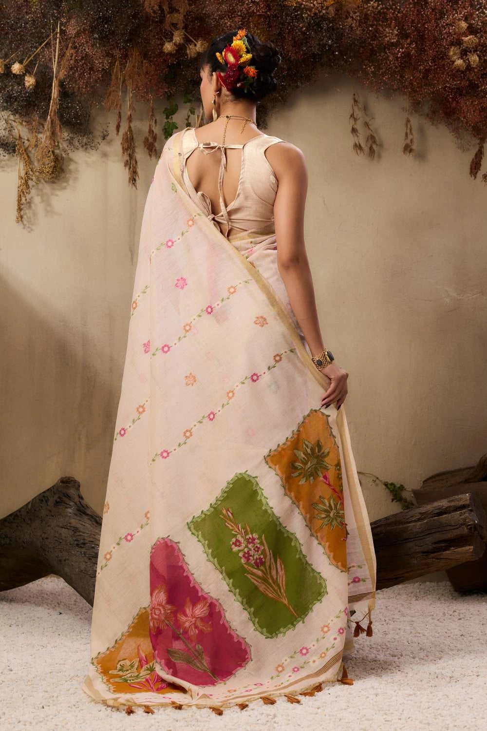 The background has hanging dried flowers and earthy tones, creating a rustic aesthetic.
