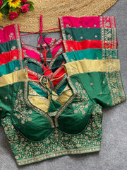 Green embroidered blouse with red and gold accents on a gray surface