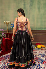 Back view of black heavy embroidered lehenga with colorful patola border and Kutchi choli lace-up back