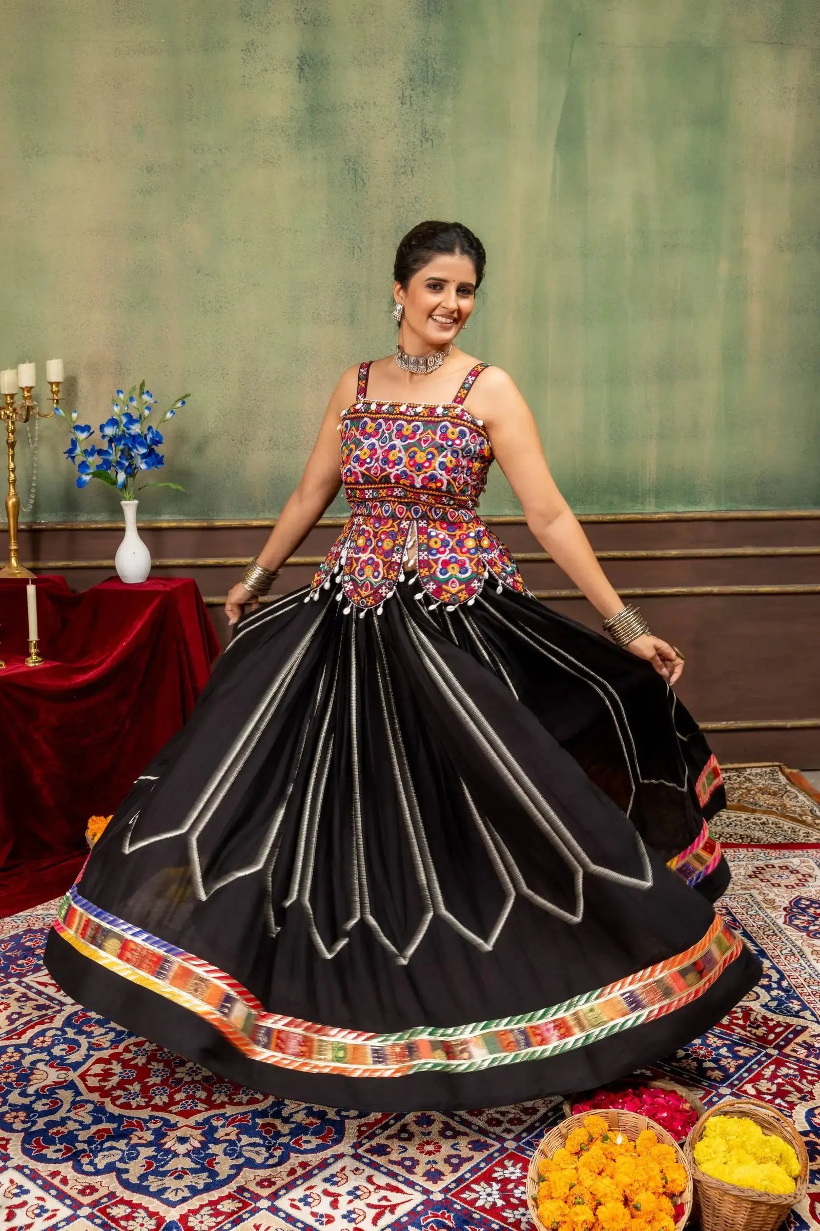 Black heavy embroidered Kutch work lehenga with multicolor choli, twirling front view