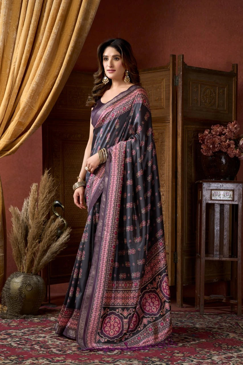 Woman wearing a traditional saree in a decorative indoor setting