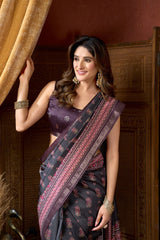 Woman wearing a traditional saree in a warm-toned room