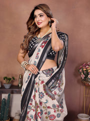 Woman wearing a floral saree with a black blouse against a brown background