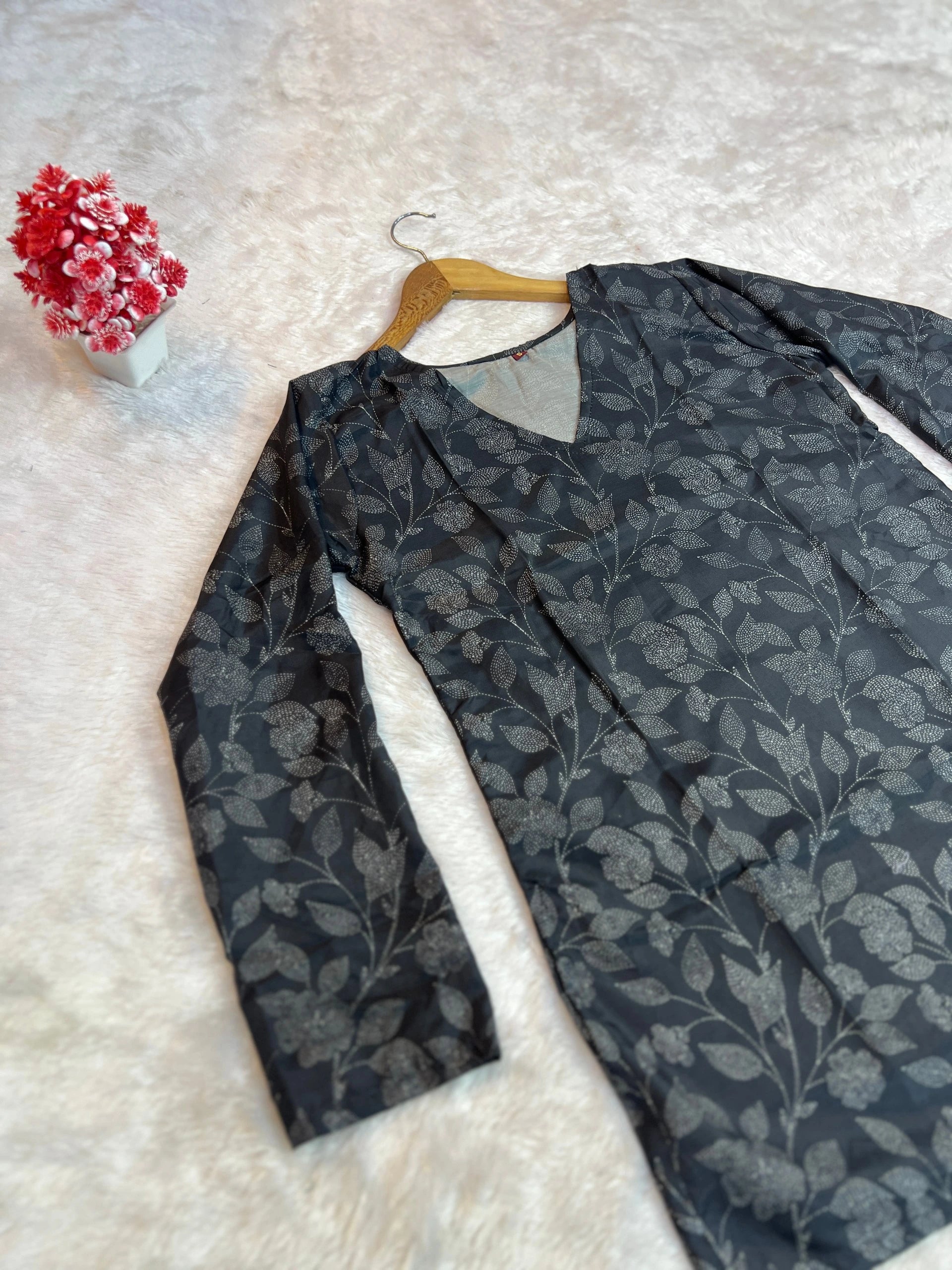Floral-patterned garment on a hanger with a white background