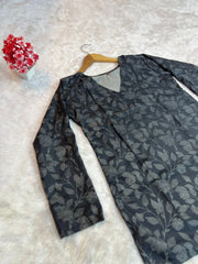 Floral-patterned garment on a hanger with a white background