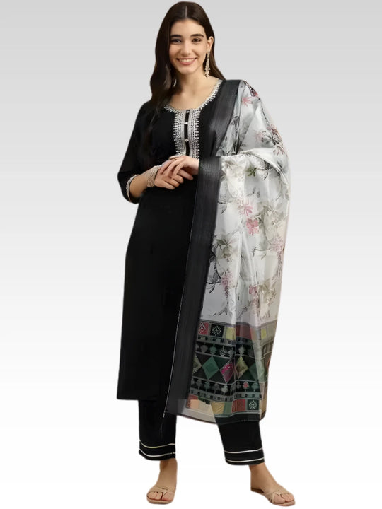 Woman wearing a black kurta with floral dupatta on a white background