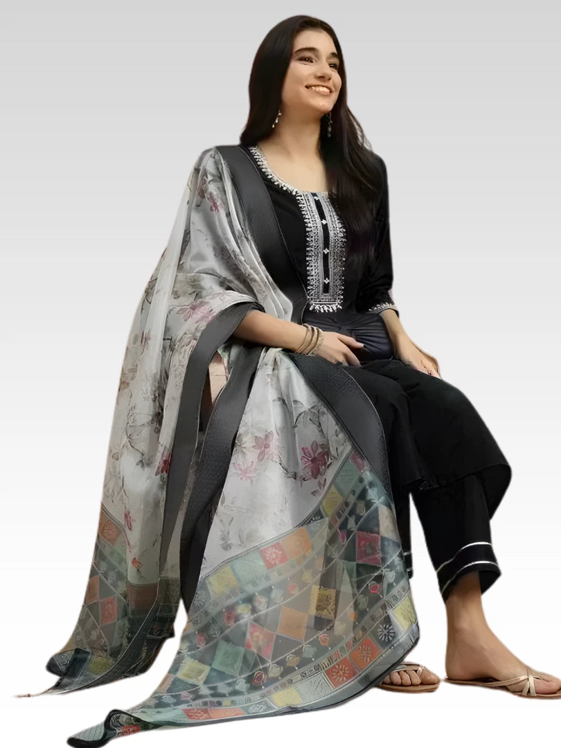 Woman wearing a floral dupatta over a black outfit on a white background