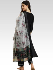 Woman wearing a traditional outfit with a floral dupatta on a white background