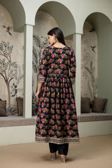 Woman wearing a floral dress in an archway with decorative walls.