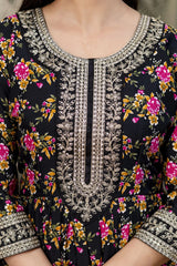 Close-up of a black floral dress with intricate silver embroidery