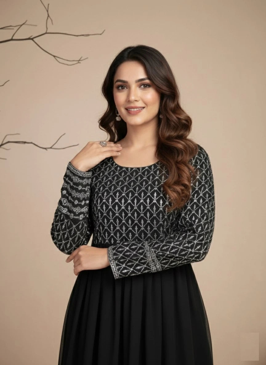 Woman wearing a black and gray patterned top against a beige background