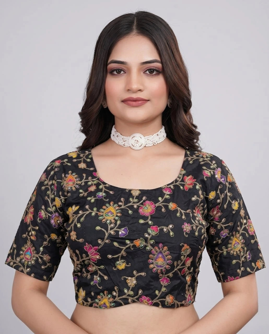 Black viscose blouse with elegant embroidery and position print displayed on mannequin.