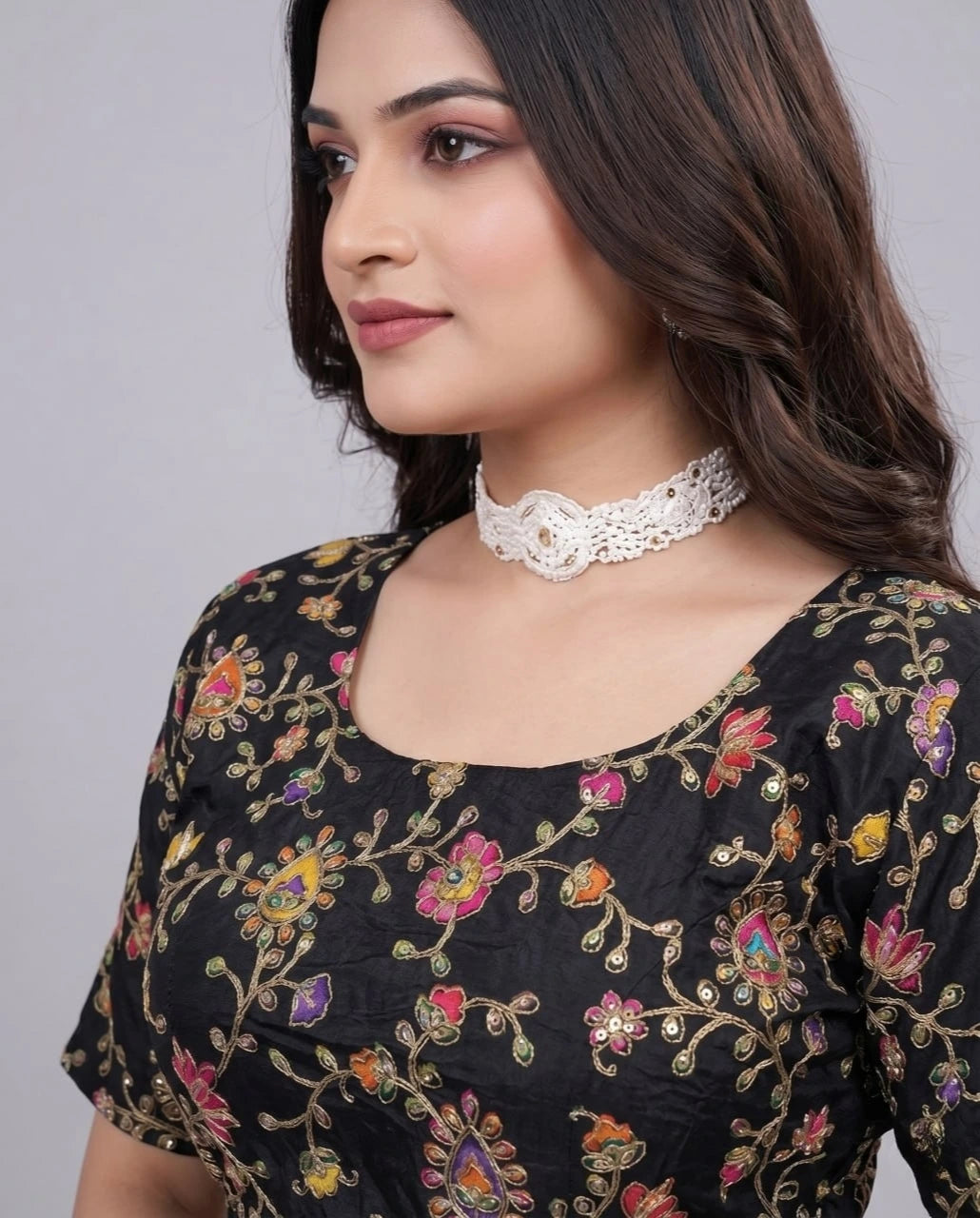 Designer black blouse with embroidery on neckline and position print patterns.