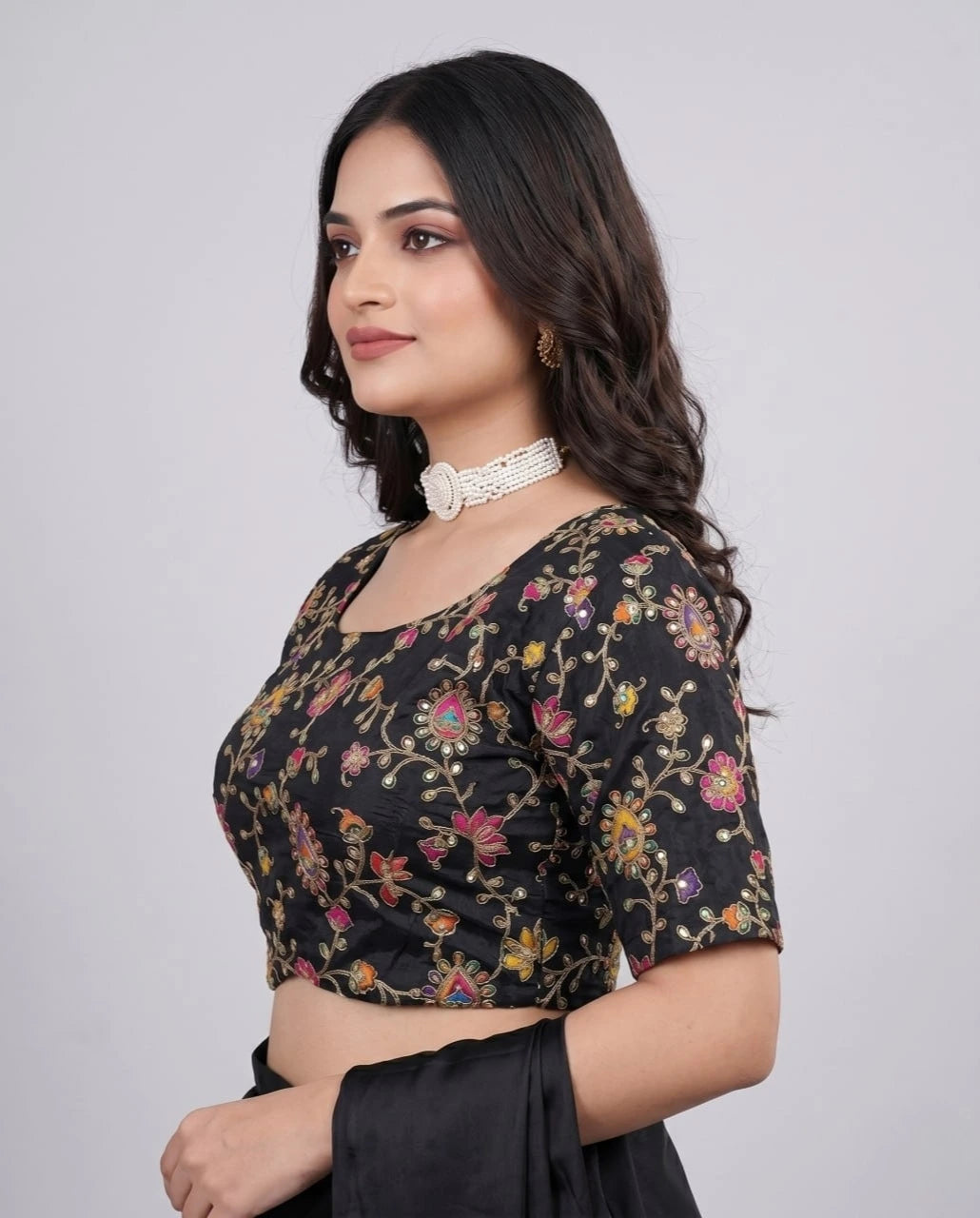 Luxurious black pure viscose blouse folded neatly, showcasing embroidery and print details.