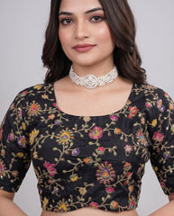 Close-up of black blouse highlighting fine embroidery and position print craftsmanship.