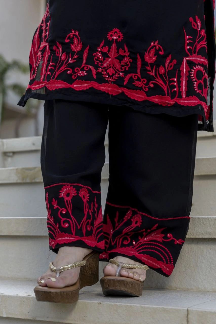 Black traditional outfit with red embroidery on steps