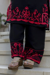 Black traditional outfit with red embroidery on steps
