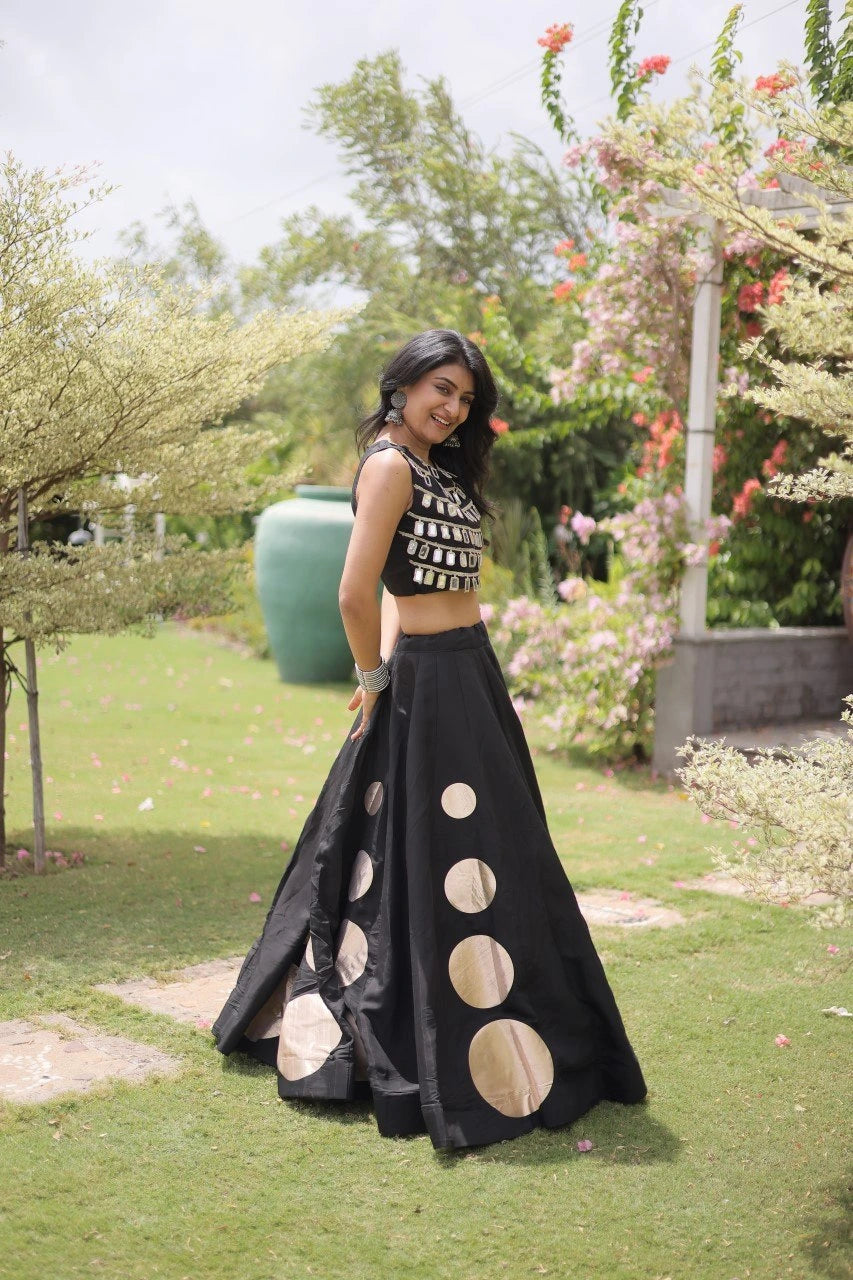 Sleeveless embellished blouse with intricate mirror work creates a stunning festive and party-ready appearance.