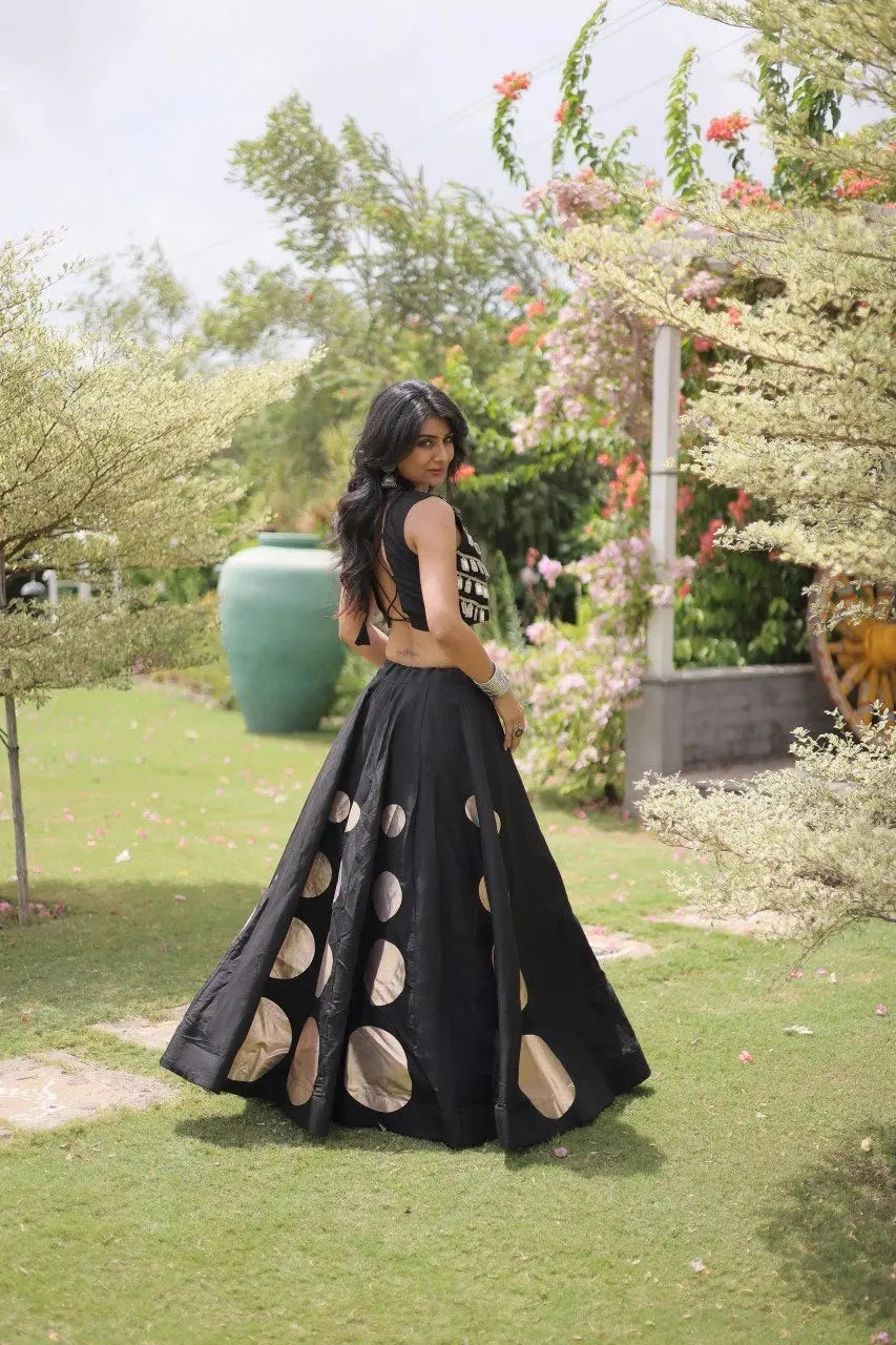Stylish ethnic outfit combining a contemporary mirror work blouse with a graceful full-flare designer skirt.