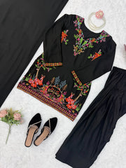 Black outfit with colorful floral embroidery on a white background