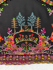Colorful embroidered design on a black fabric background