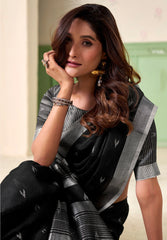 Woman wearing a black saree with a green background