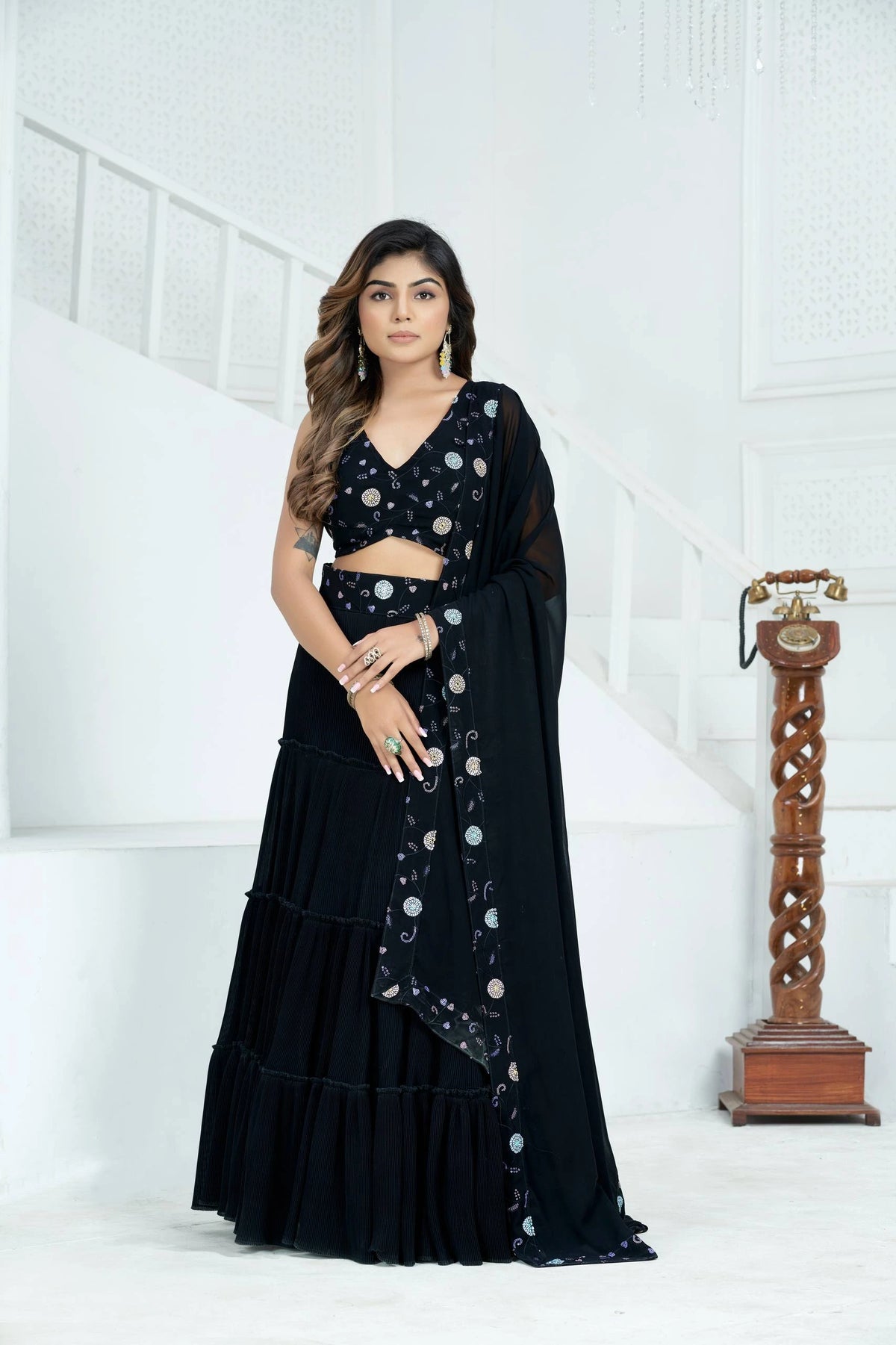 Woman wearing a black traditional outfit with a white background