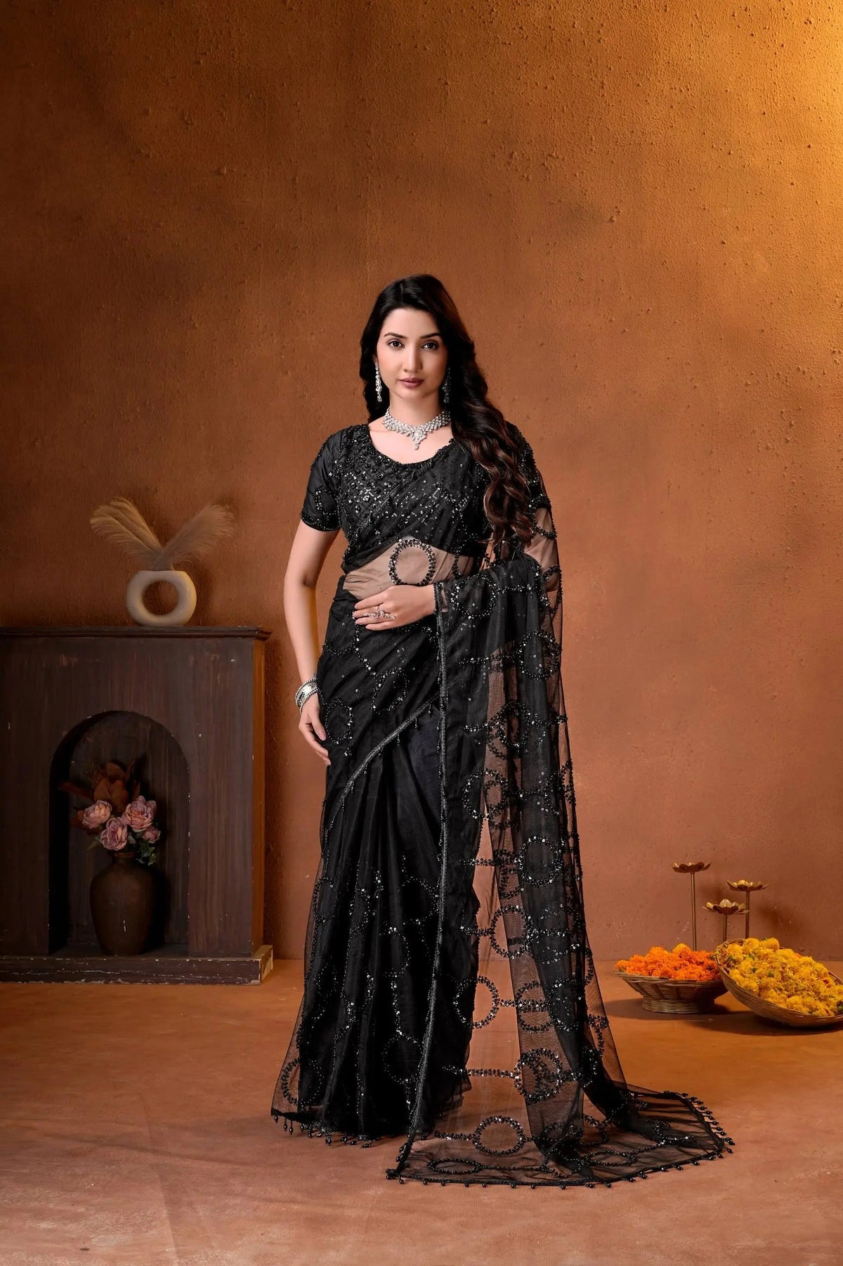 Elegant black designer saree featuring shimmering sequins embroidery and intricate handcrafted detailing for a luxurious festive look.