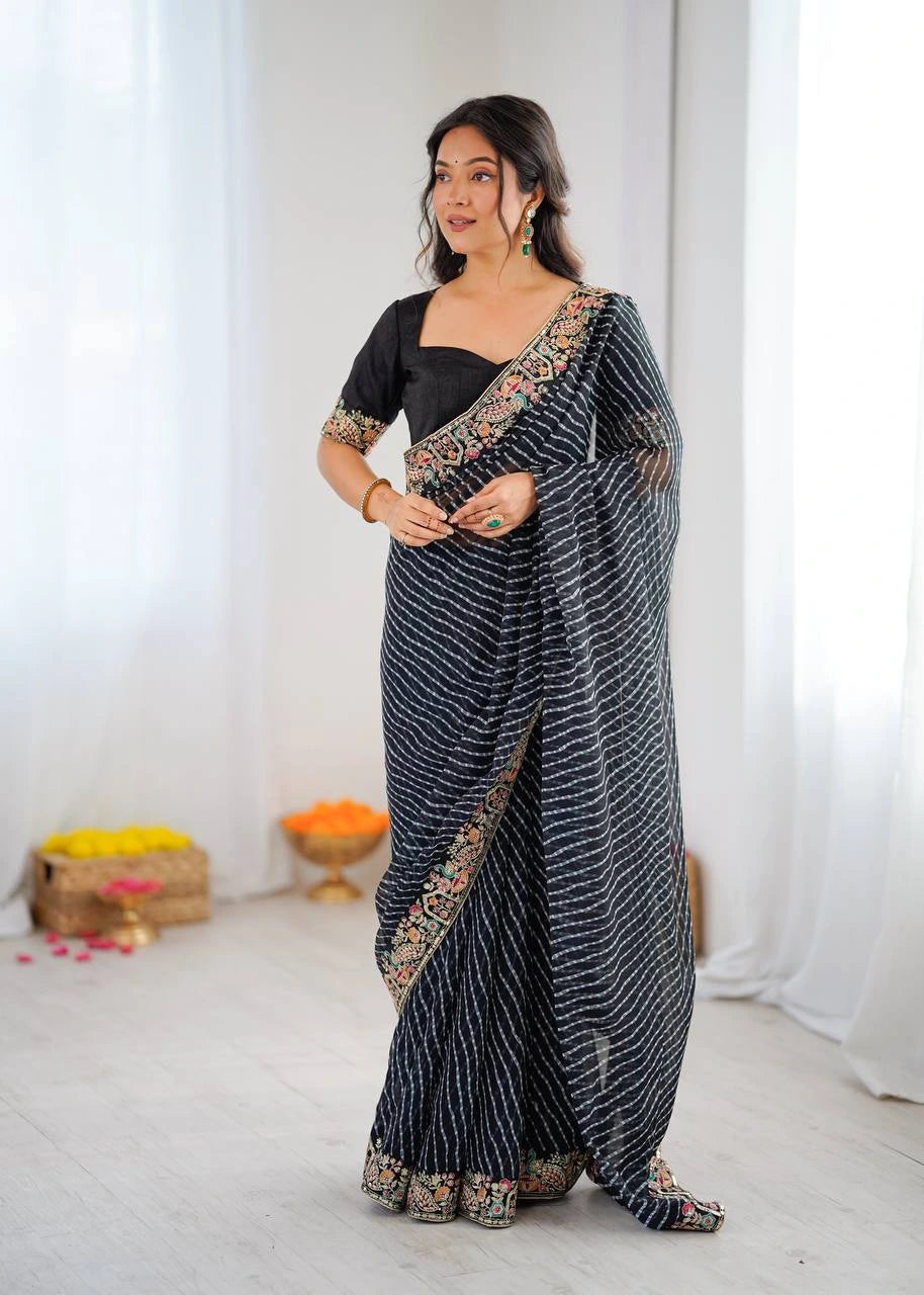 Woman wearing a black and white saree with a white background