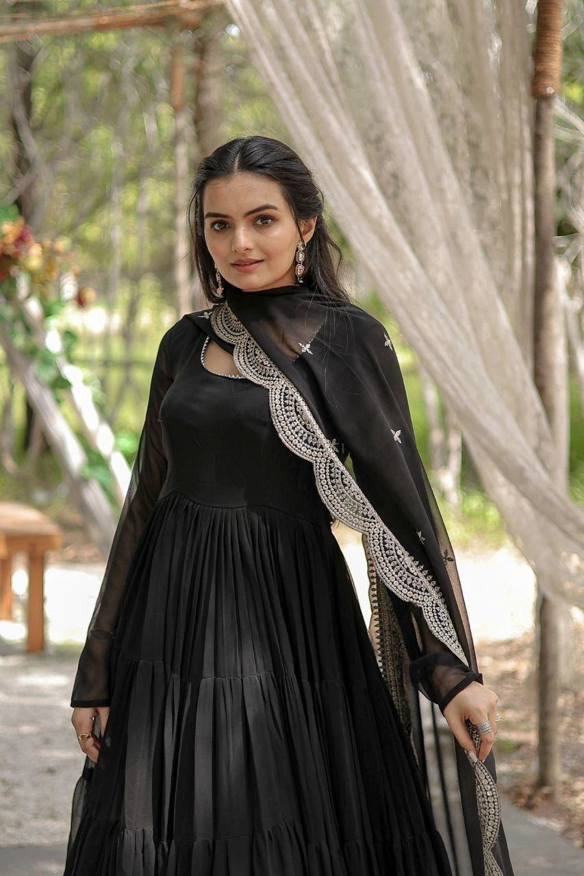 Woman wearing a black dress with lace details outdoors