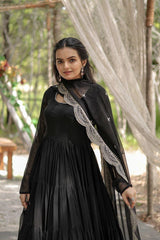 Woman wearing a black dress with lace details outdoors