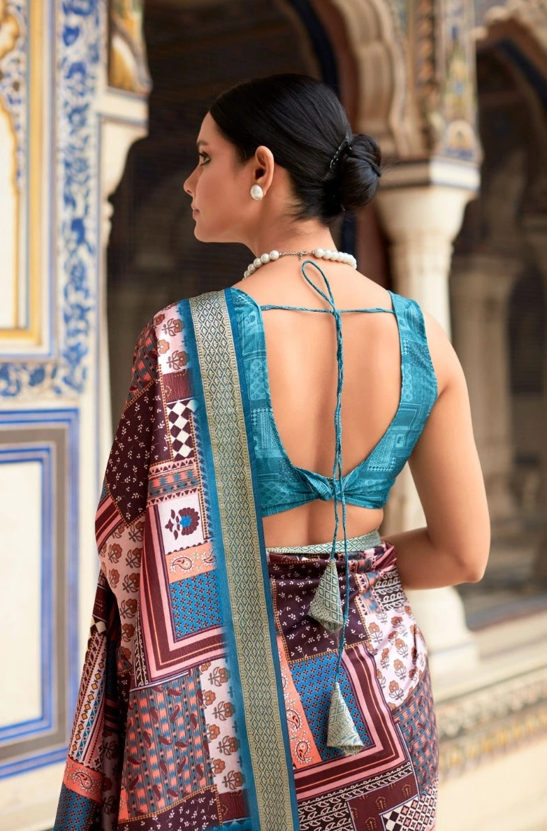 Woman wearing a traditional patterned saree with a decorative backdrop