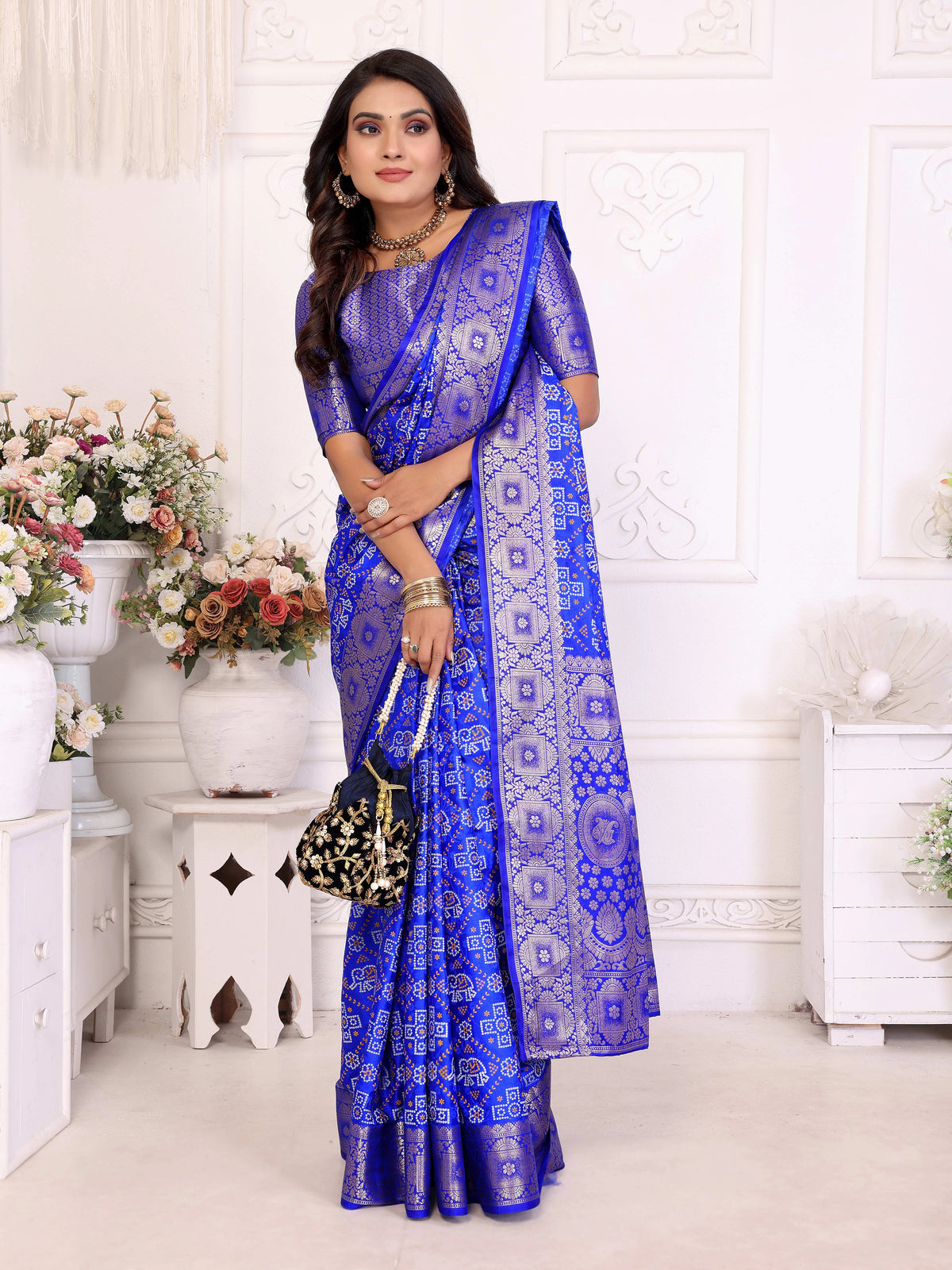 Woman wearing a blue saree with a white background