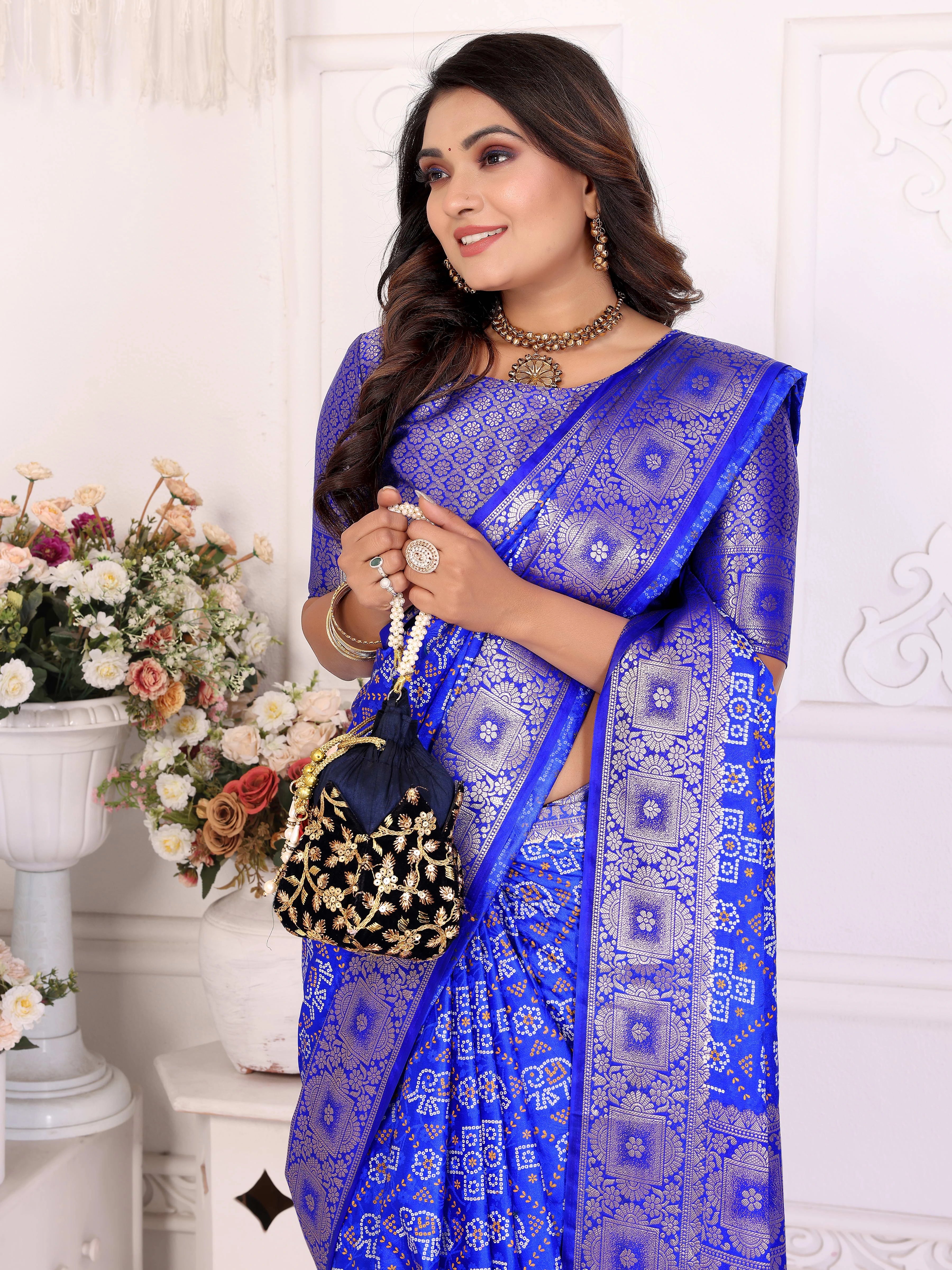 Woman wearing a blue saree with a white background