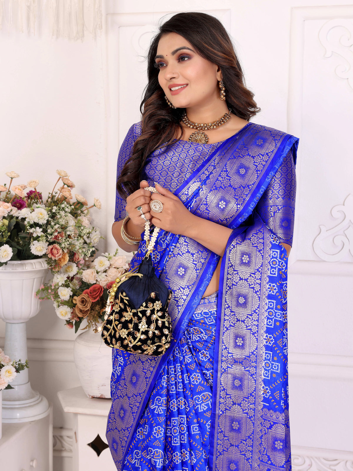 Woman wearing a blue saree with a white background