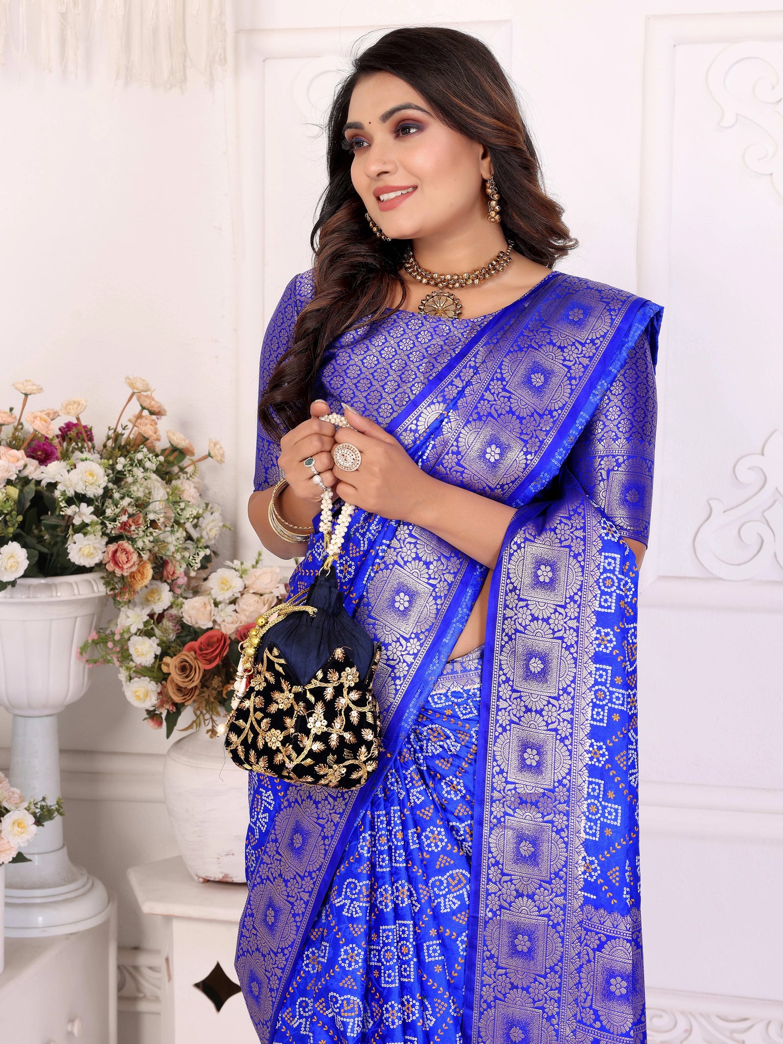 Woman wearing a blue saree with a white background